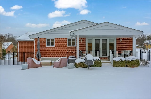 view of snow covered rear of property