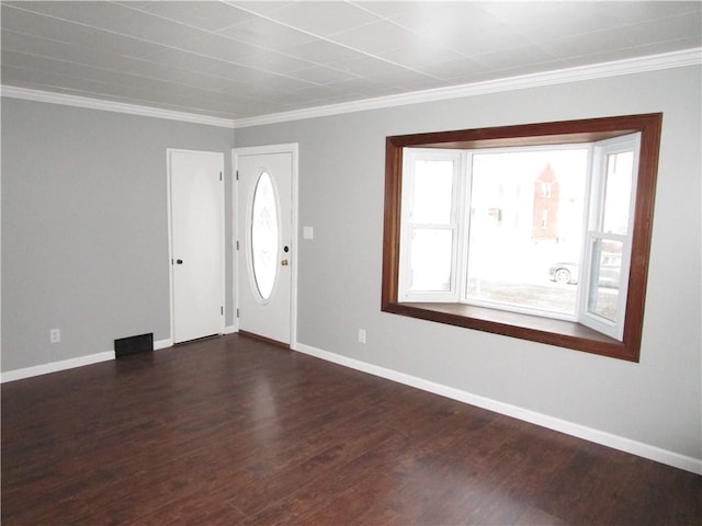 foyer entrance with crown molding and dark hardwood / wood-style floors