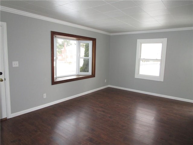 empty room with dark wood-type flooring and ornamental molding