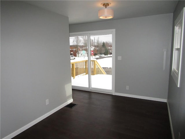 empty room featuring dark wood-type flooring