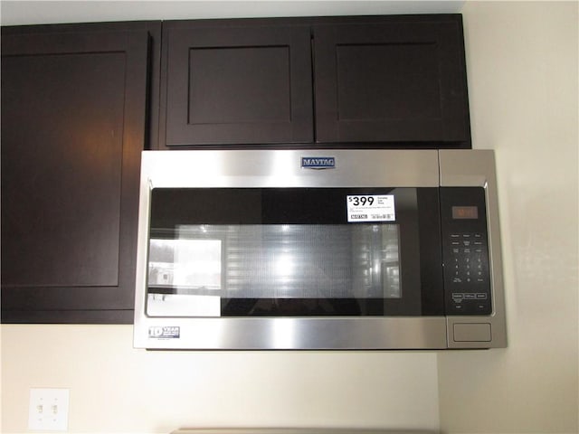 room details with stainless steel microwave and dark brown cabinetry