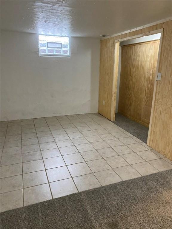 basement featuring light tile patterned floors