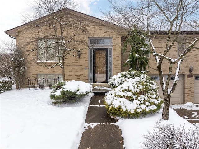 view of snowy exterior with a garage