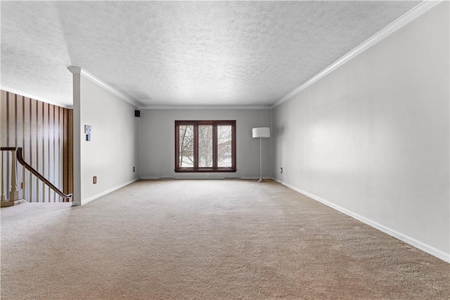 carpeted empty room with a textured ceiling and ornamental molding