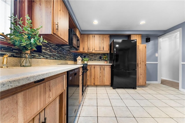 kitchen featuring black appliances, decorative backsplash, light tile patterned floors, and sink