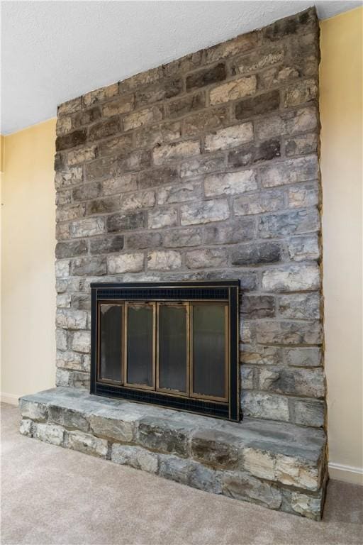 room details featuring a fireplace and carpet floors