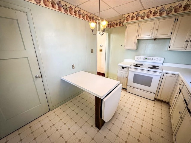 kitchen with light floors, electric range, a drop ceiling, light countertops, and pendant lighting