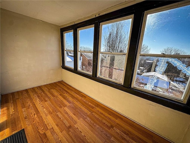 spare room with wood finished floors