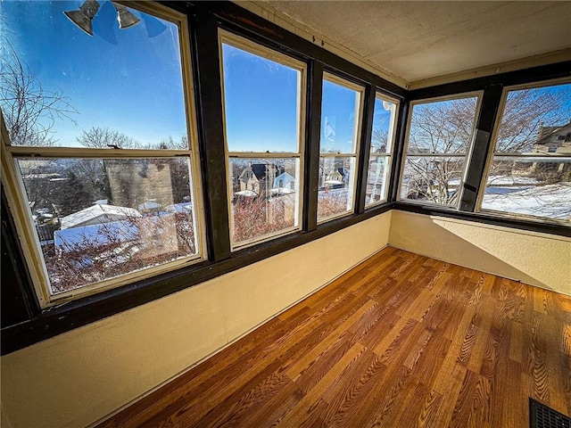 unfurnished sunroom with plenty of natural light and visible vents