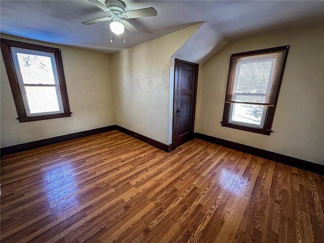 additional living space featuring wood finished floors, baseboards, and a wealth of natural light