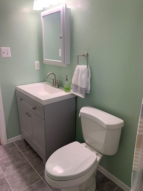 bathroom with tile patterned floors, vanity, and toilet