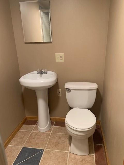 bathroom featuring tile patterned flooring and toilet