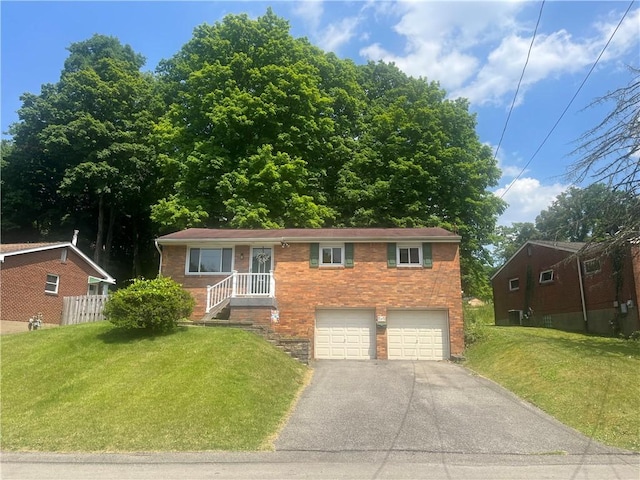 view of front of home with a garage and a front yard