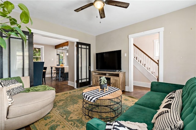 living room featuring dark hardwood / wood-style flooring and ceiling fan