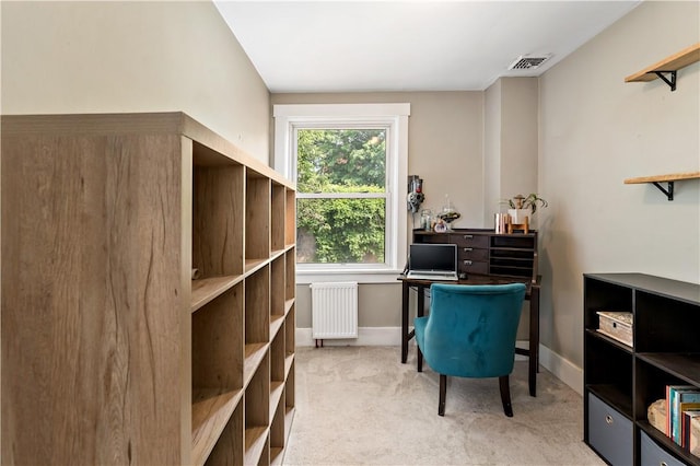 carpeted office space with radiator heating unit and a healthy amount of sunlight