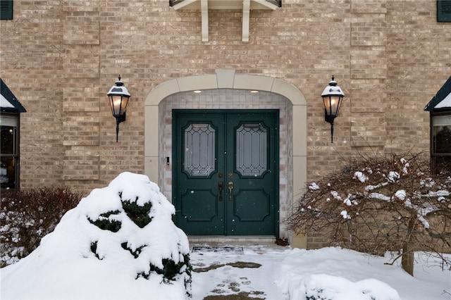 view of snow covered property entrance