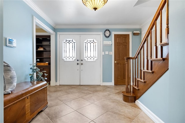 entrance foyer with light tile patterned flooring and ornamental molding