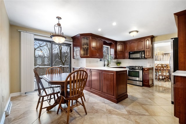 kitchen with hanging light fixtures, stainless steel appliances, and sink