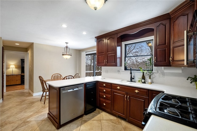 kitchen featuring black gas range, hanging light fixtures, stainless steel dishwasher, light tile patterned flooring, and kitchen peninsula