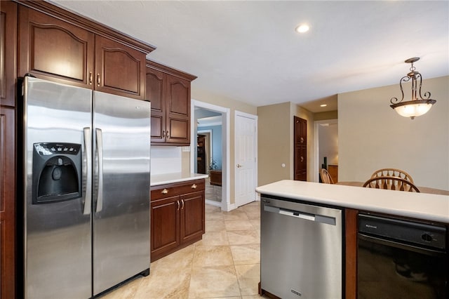 kitchen with dark brown cabinets, light tile patterned floors, hanging light fixtures, and appliances with stainless steel finishes