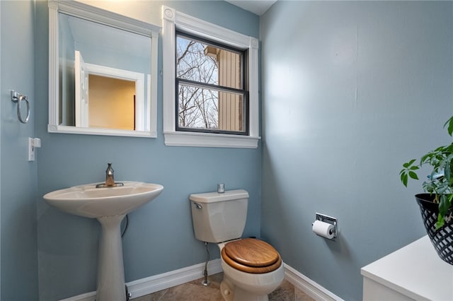 bathroom featuring tile patterned flooring and toilet