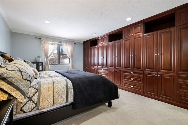 bedroom featuring light carpet, a textured ceiling, and crown molding