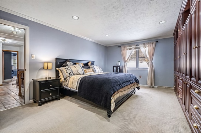 bedroom featuring a textured ceiling, crown molding, and light carpet