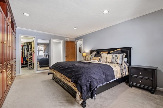 bedroom with a spacious closet, a closet, light colored carpet, and ornamental molding