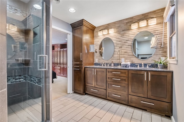 bathroom featuring vanity and a shower with shower door