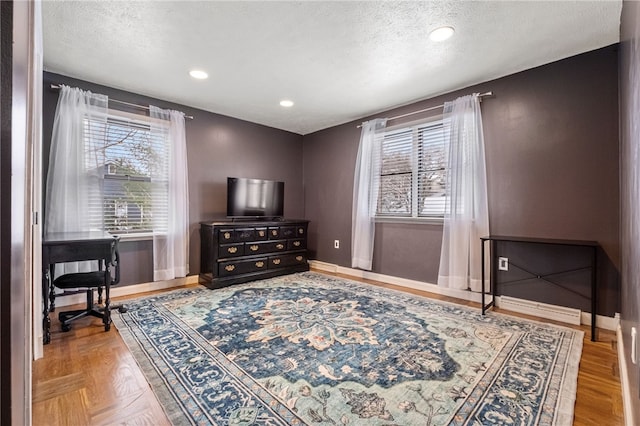 sitting room featuring a textured ceiling and parquet floors