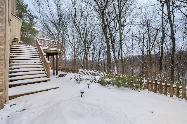 yard layered in snow with a deck