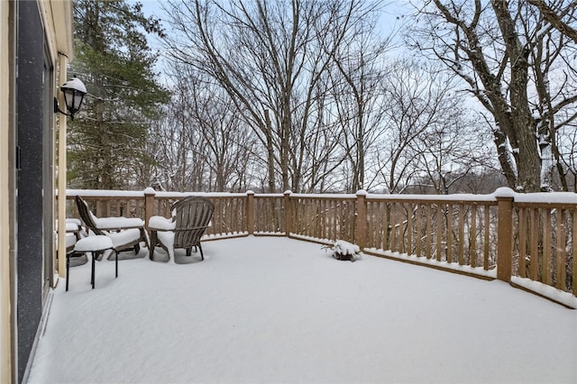 snow covered patio with a deck