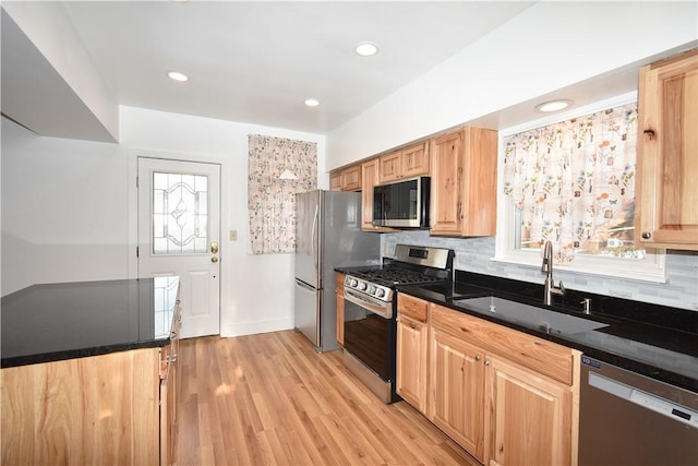 kitchen featuring sink, decorative backsplash, plenty of natural light, and stainless steel appliances