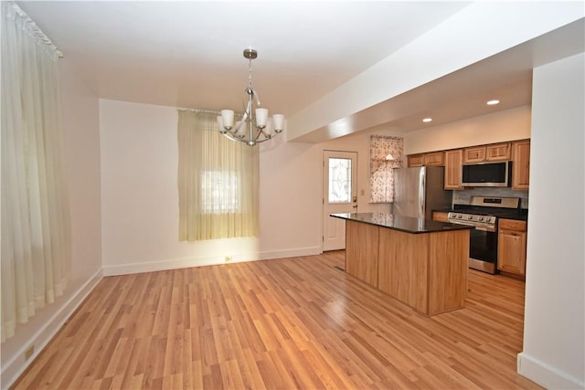 kitchen with a center island, hanging light fixtures, a notable chandelier, stainless steel appliances, and light hardwood / wood-style floors