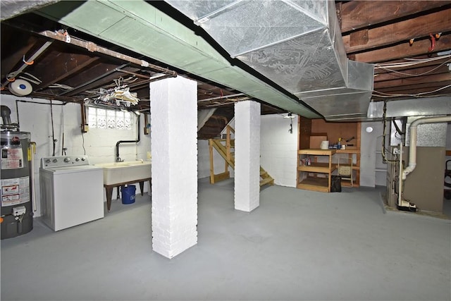 basement featuring washer / dryer, sink, and gas water heater