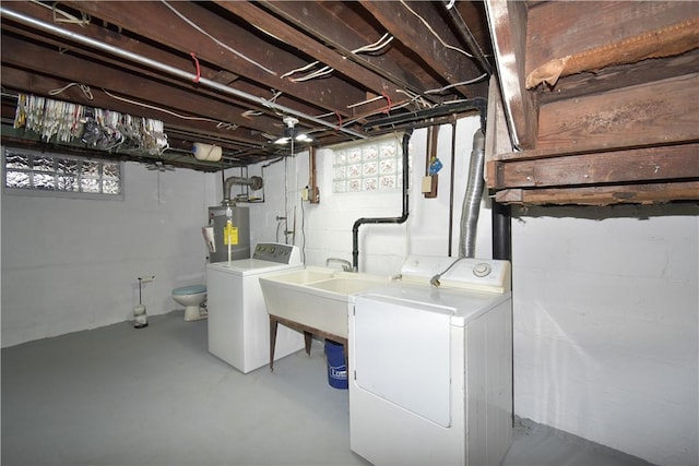 clothes washing area with water heater and washer and dryer