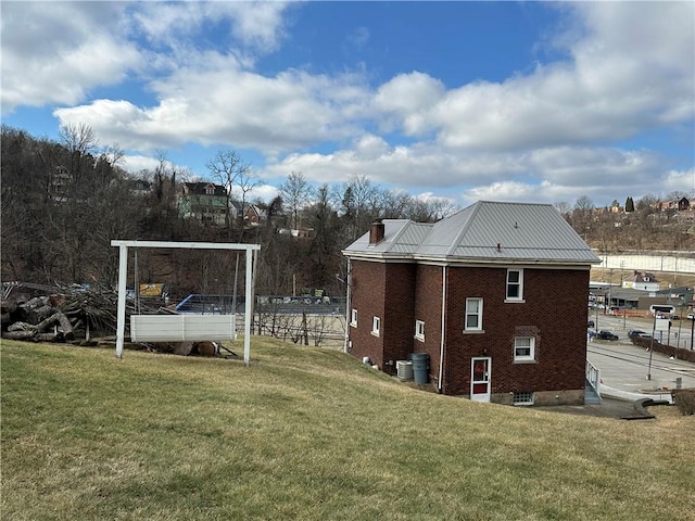 view of side of home featuring a yard