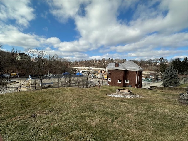 view of yard with a fire pit