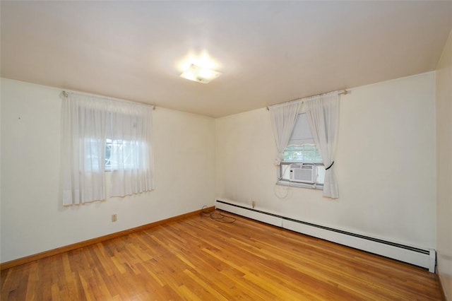 empty room featuring a baseboard radiator, cooling unit, and hardwood / wood-style floors