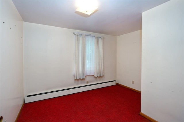 carpeted spare room featuring a baseboard radiator