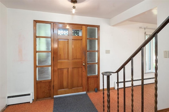 foyer entrance with baseboard heating and carpet flooring