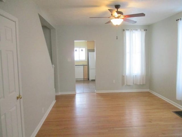 spare room featuring ceiling fan and light hardwood / wood-style flooring