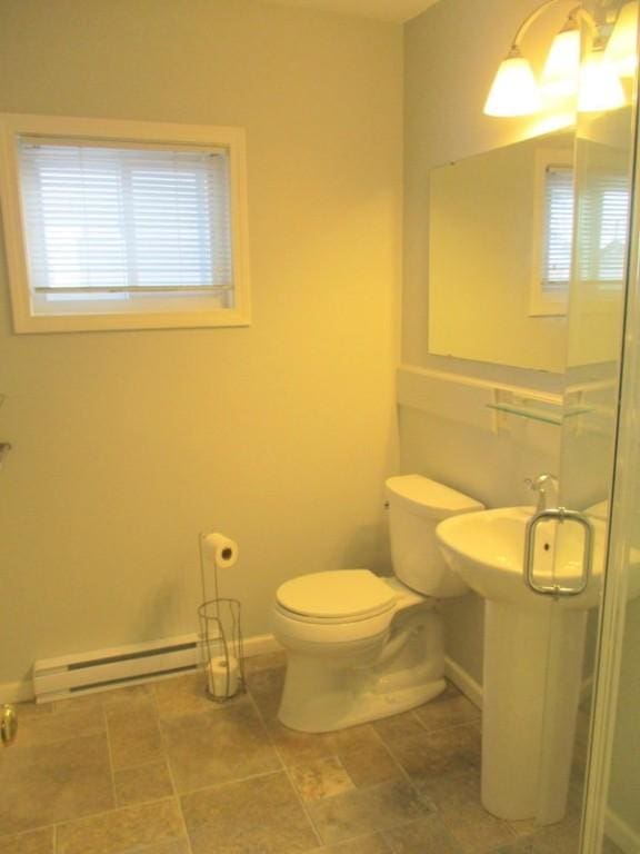 bathroom with toilet and a baseboard radiator