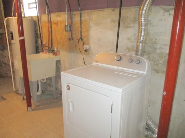 clothes washing area featuring washer / dryer and gas water heater