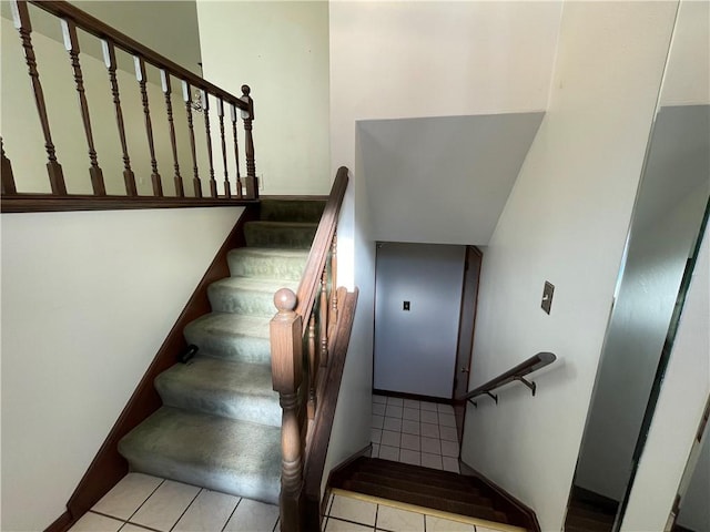 stairs featuring tile patterned flooring