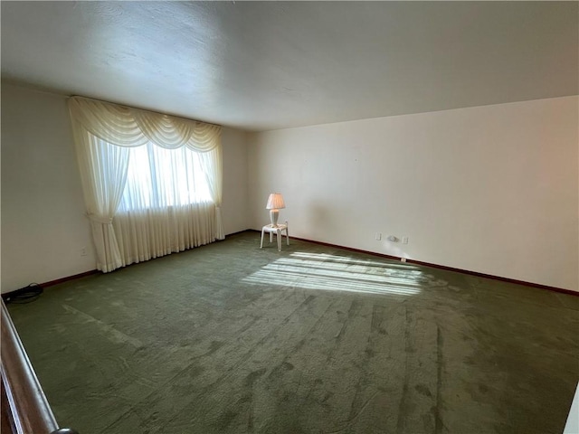 empty room with dark colored carpet