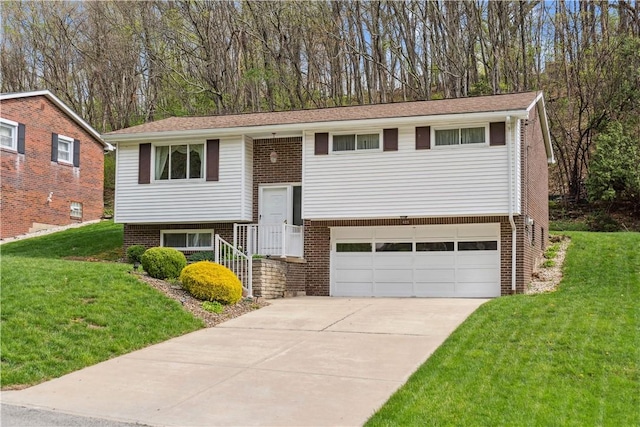 raised ranch featuring an attached garage, a front lawn, brick siding, and concrete driveway