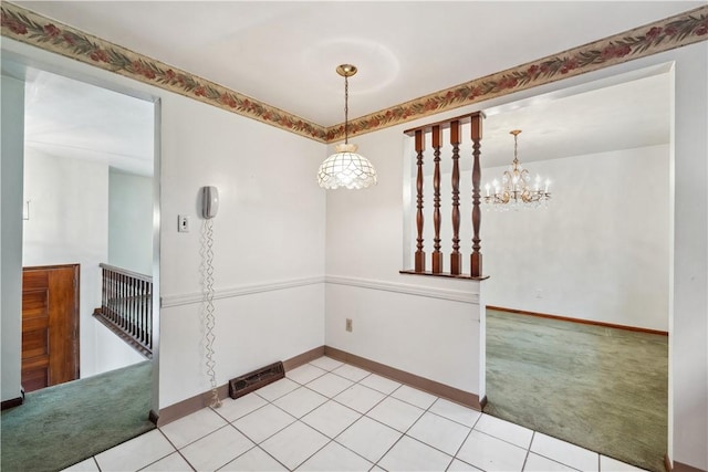 empty room with baseboards, a notable chandelier, light colored carpet, and light tile patterned flooring