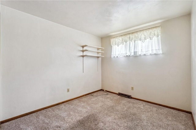 carpeted empty room with baseboards and visible vents