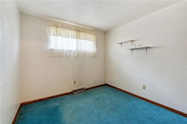 carpeted spare room with baseboards and visible vents